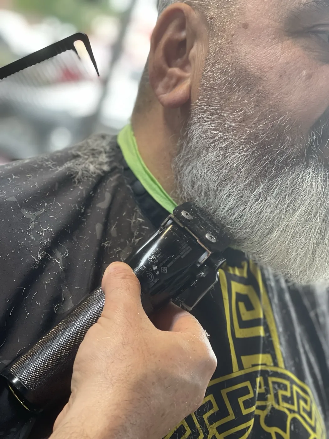 Beard lineup and trim with clipper under jaw