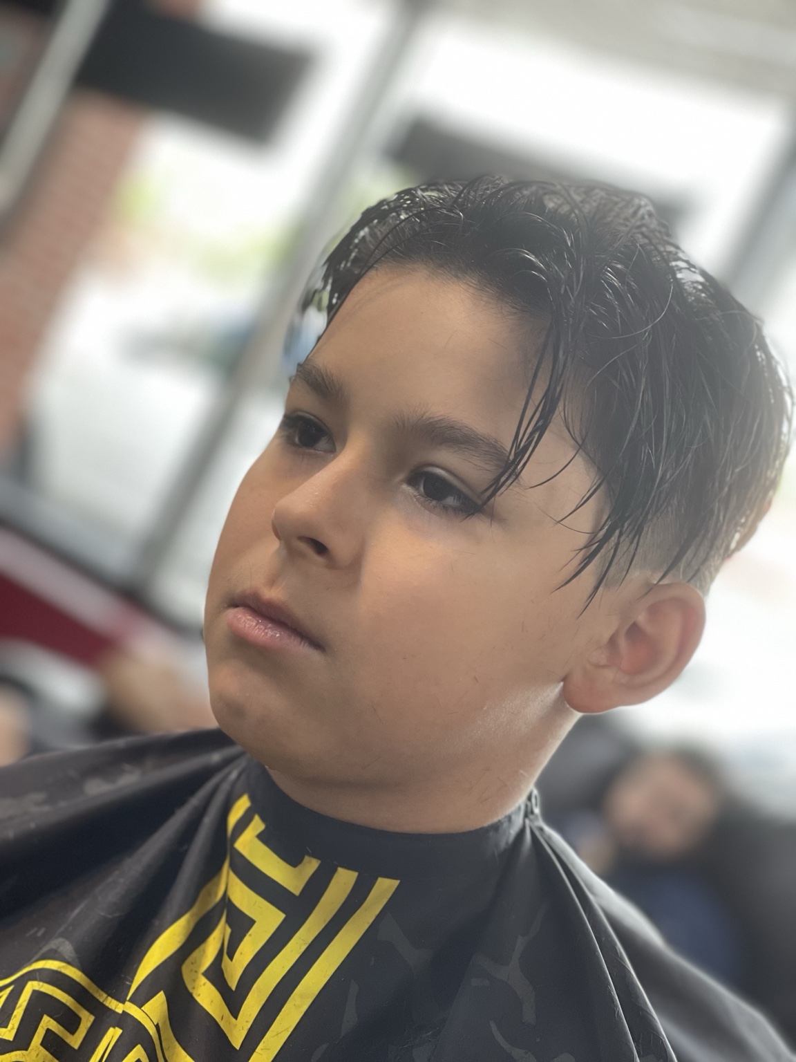 Kids haircut with wet textured top and low fade