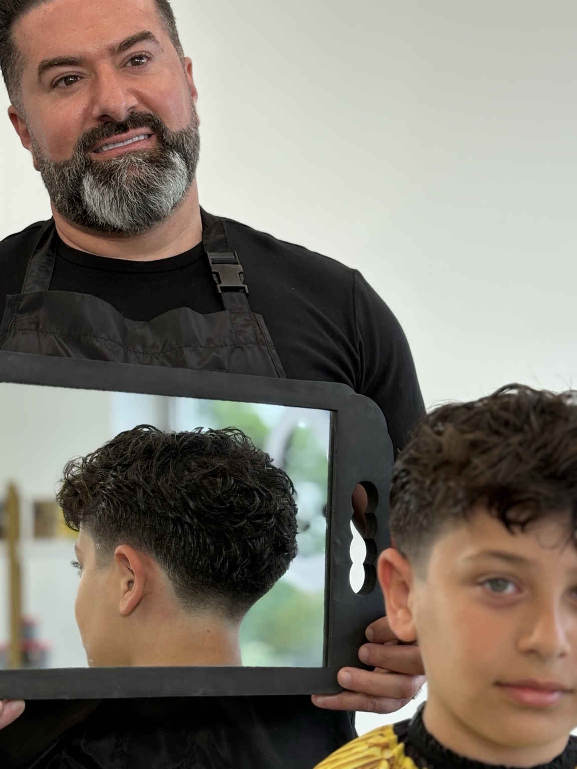 Curly top with mid drop fade, mirror reveal