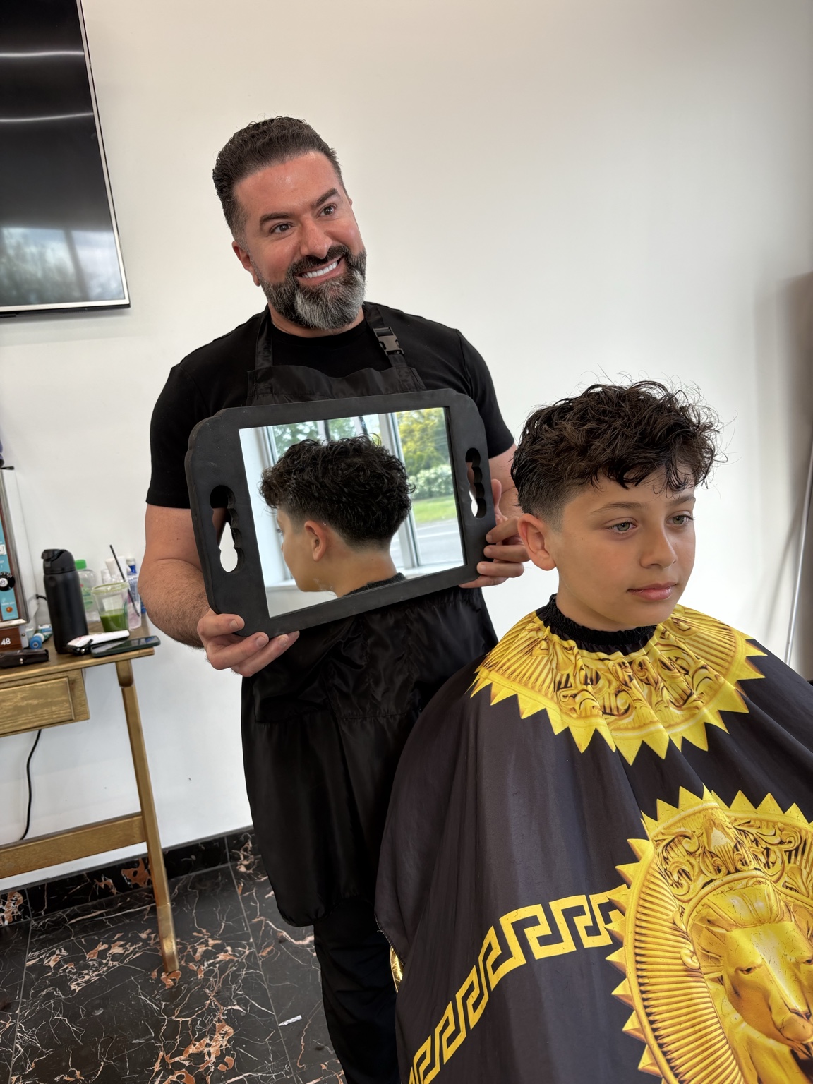 Curly top with mid drop fade mirror reveal