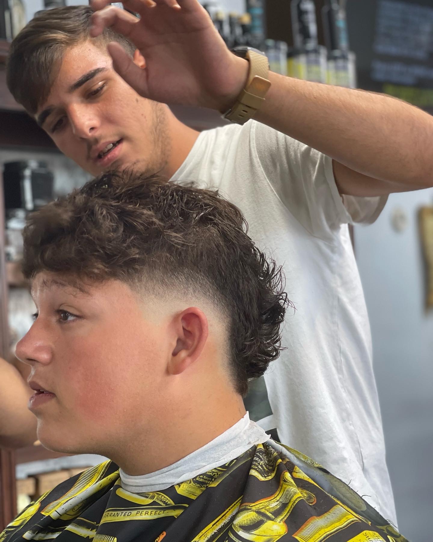 Curly mullet style with low drop fade