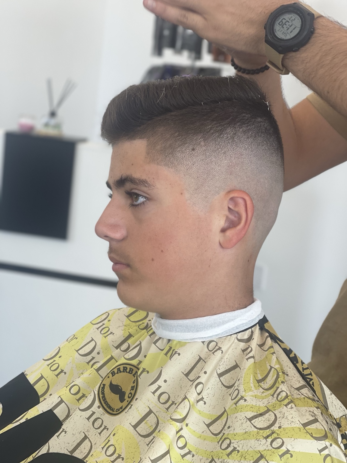 Sharp high fade with combed top