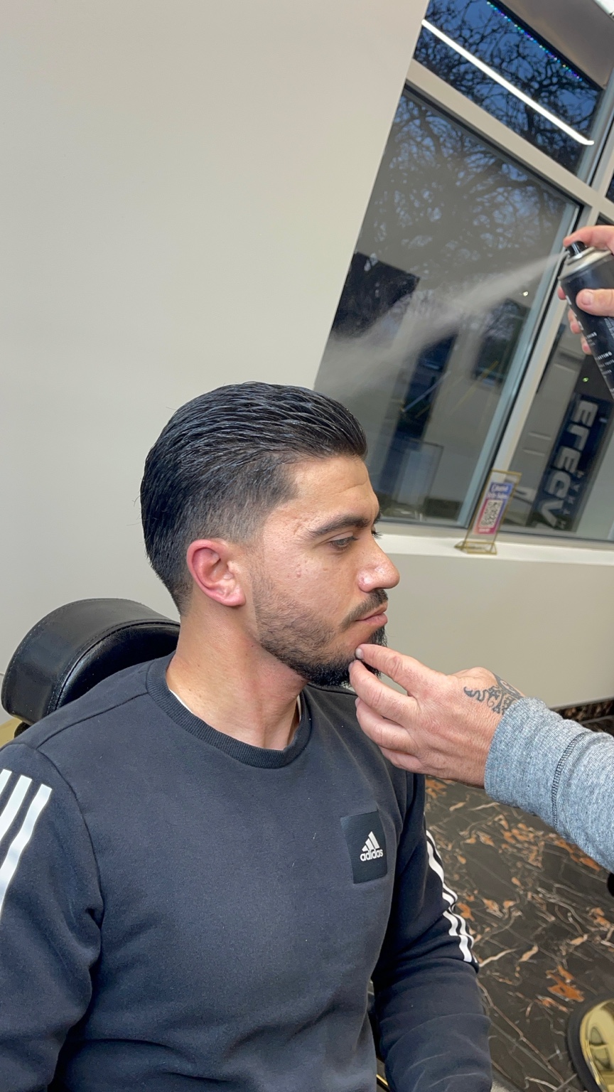 Beard trim with slick back low fade